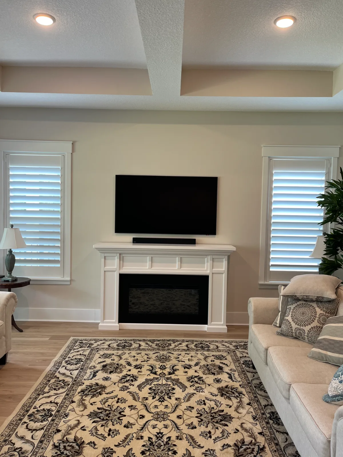 Decorative electric fireplace and wall-mounted TV with concealed cable management in Nocatee, FL
