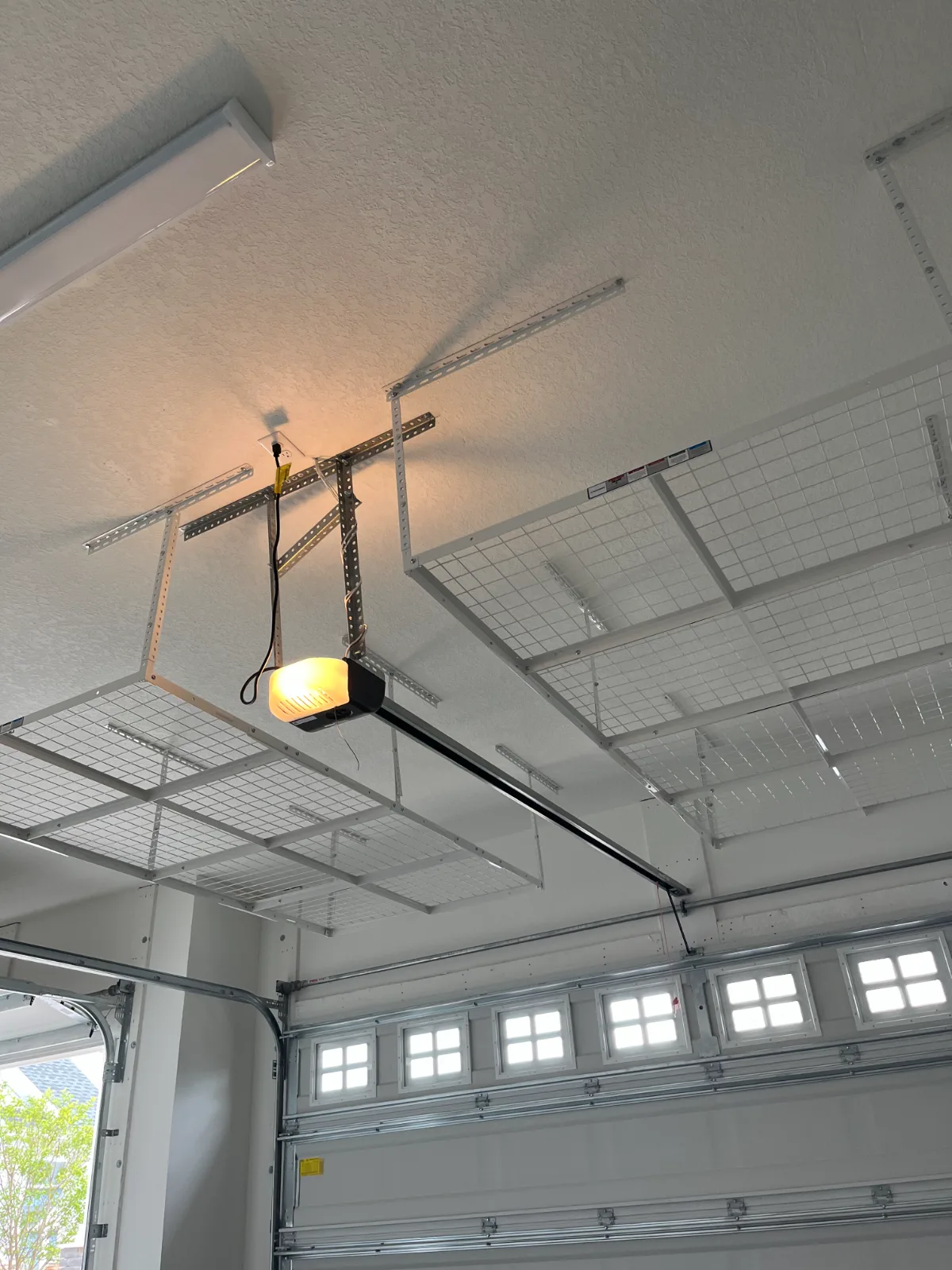 Garage ceiling storage rack installed above the garage door in Nocatee, FL